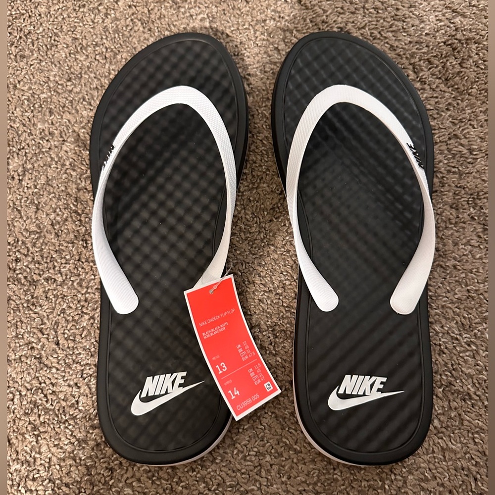 Nike ondeck black and white flip flops.